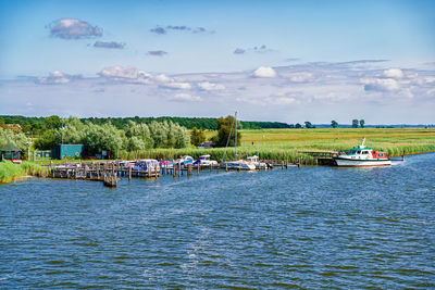 Boats in sea against sky