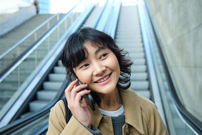 Portrait of young woman looking away outdoors