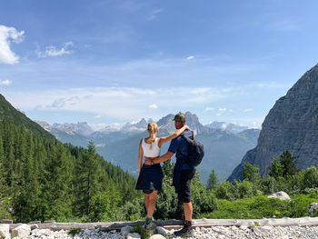 Couple hugging overlooking the dolomite mountains