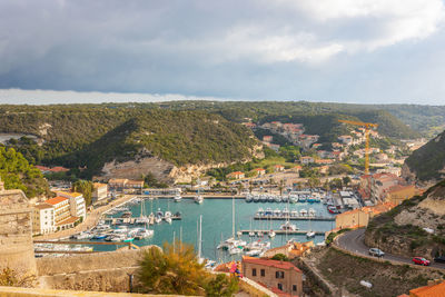 High angle view of townscape by sea against sky