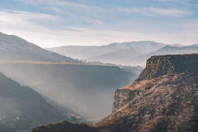 Scenic view of mountains against cloudy sky