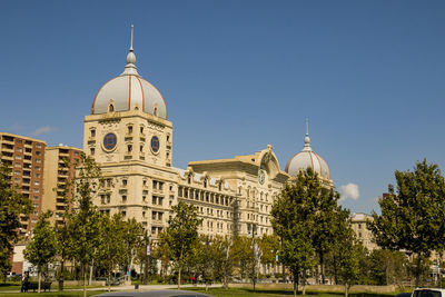 View of buildings in city against clear sky