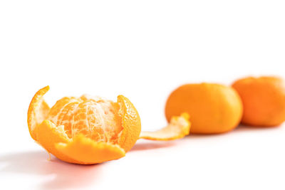 Close-up of orange fruit against white background