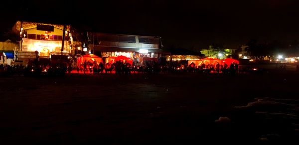 Group of people in illuminated city at night