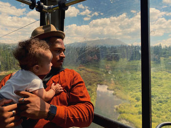 Father and son on window