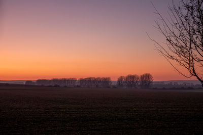 Scenic view of field against sky during sunset