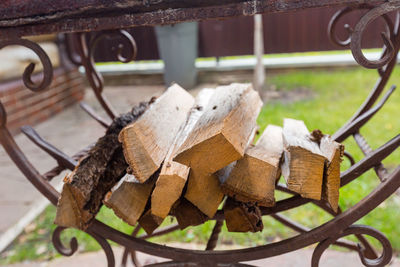 Firewood in the yard on an iron grate