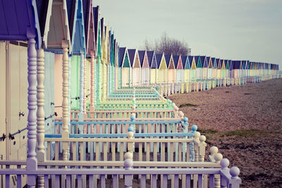 A view of typical english style colourful beach huts on the island of west mersea in the uk.