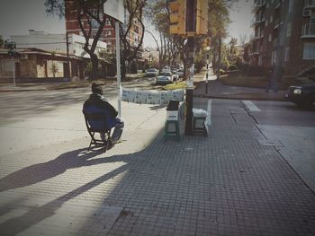 Man cycling on street in city