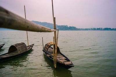 Boat moored on sea against sky