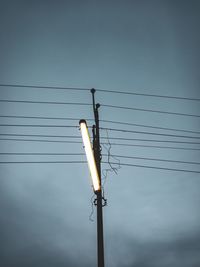 Low angle view of electricity pylon against sky