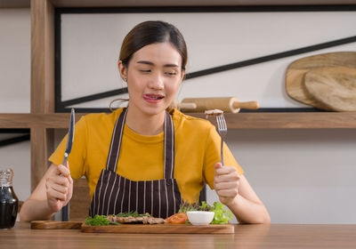 Portrait of woman sitting at restaurant table