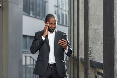 Young businessman using mobile phone