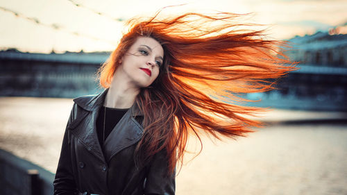 Portrait of young woman with hair blowing in wind