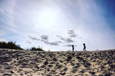 Two children walking on beach