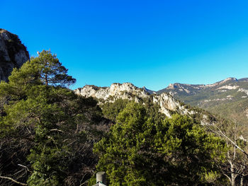 Scenic view of mountains against clear blue sky