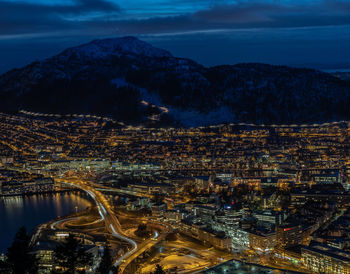 High angle view of illuminated buildings in city at night