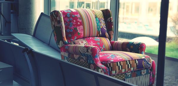 Multi colored chairs on sofa at home