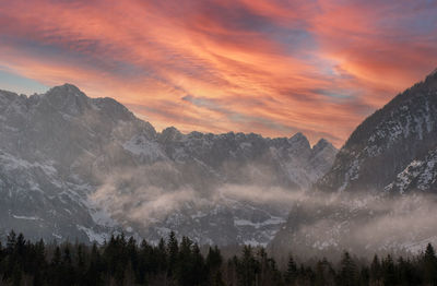 Panoramic view of snowcapped mountains against sky during sunset at tamar valley in slovenia