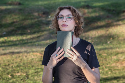 Portrait of mid adult man standing on field