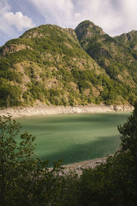 Scenic view of lake and mountains against sky