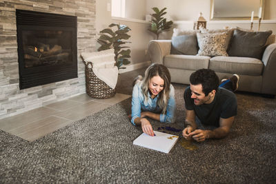 Woman sitting on sofa at home