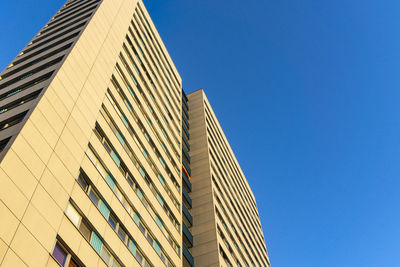 Low angle view of modern building against clear blue sky