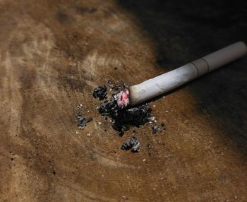 High angle view of cigarette smoking on wood