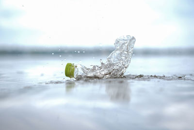 Close-up of ice crystals on water against sea