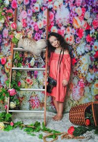 Full length of woman standing against plants