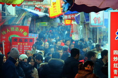 Low angle view of people in shopping mall