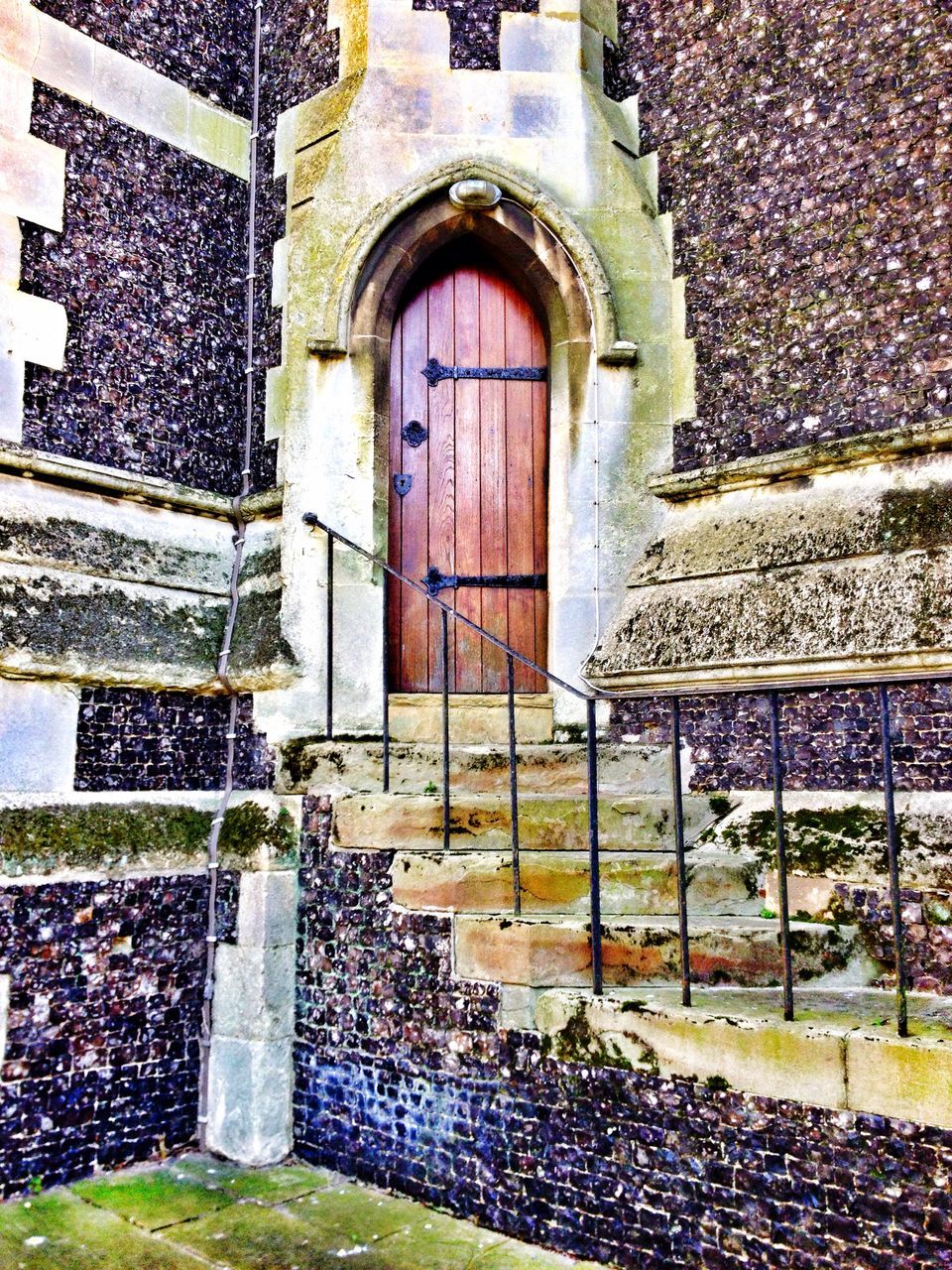 building exterior, architecture, built structure, window, day, wall - building feature, arch, door, brick wall, outdoors, entrance, closed, plant, facade, ivy, stone wall, house, no people, green color, building