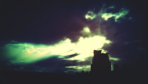 Low angle view of building against cloudy sky