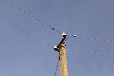 Low angle view of electricity pole against sky