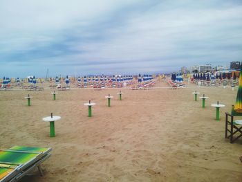 Panoramic view of people on beach against sky