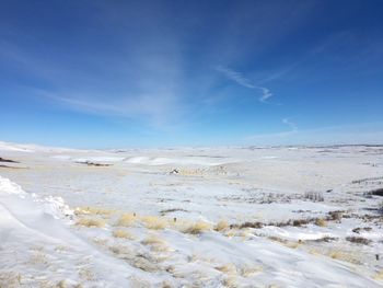 Scenic view of snow landscape against blue sky