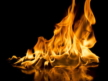 Close-up of bonfire against black background