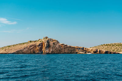 Scenic view of sea against clear blue sky