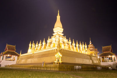 Low angle view of illuminated temple building against sky at night