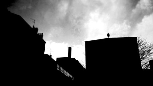 Low angle view of building against cloudy sky