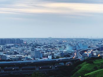 High angle view of road by buildings against sky