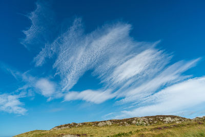 Low angle view of mountain against blue sky