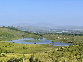 Lake and river katun in the foothills of altai on a sunny summer day, russia