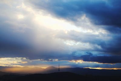 Scenic view of mountains against cloudy sky