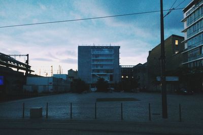 Buildings in city against cloudy sky