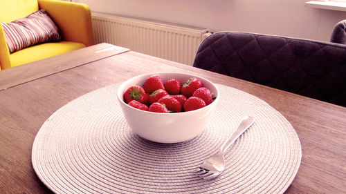 Fruits in bowl on table