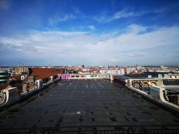 High angle view of buildings in city against cloudy sky