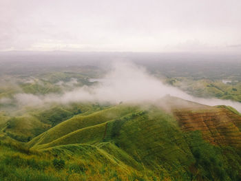 Scenic view of fog over land