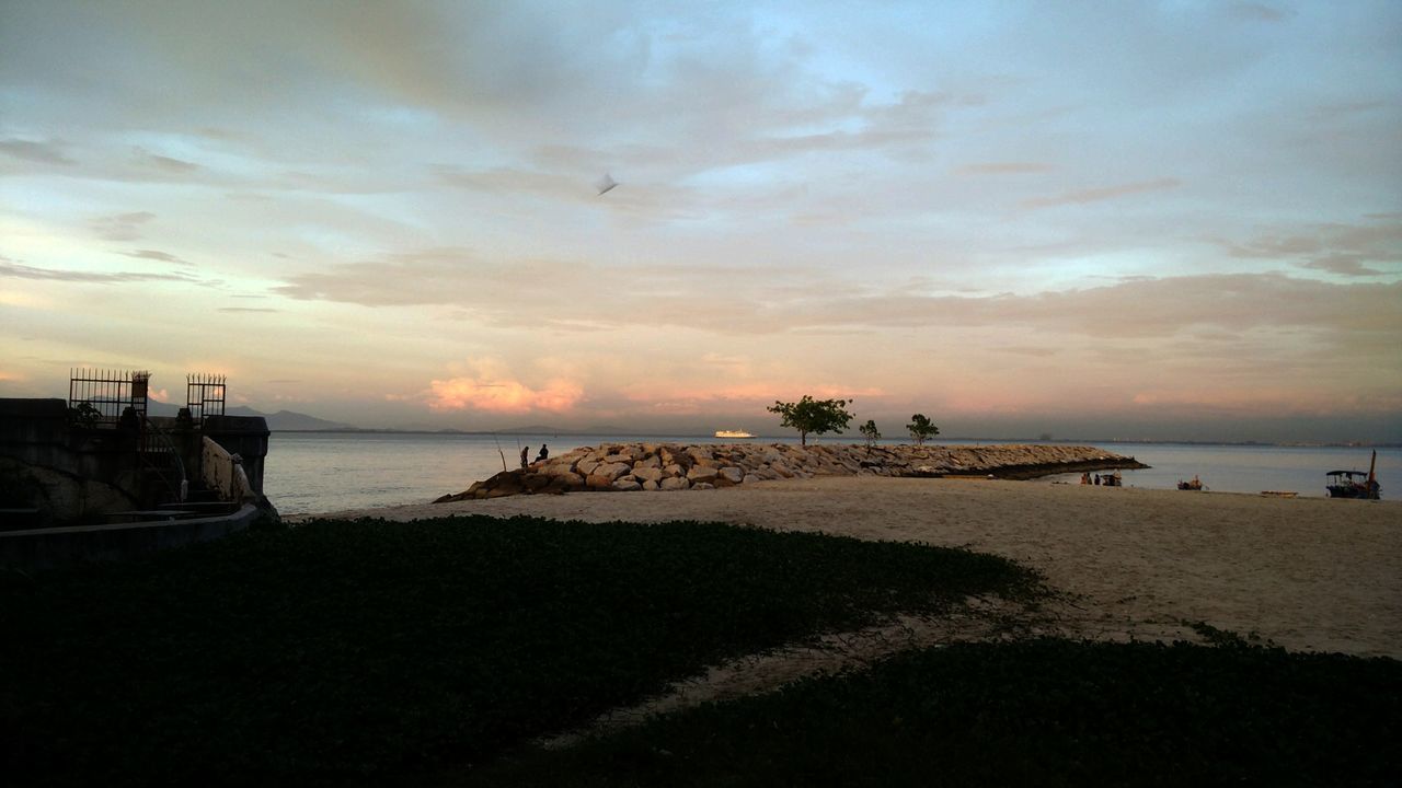 SCENIC VIEW OF BEACH DURING SUNSET