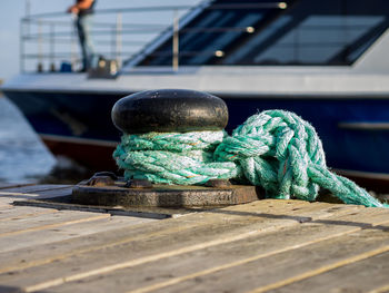 Close-up of rope tied on cleat at pier